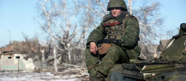 Independence supporter of self-proclaimed Donetsk People's Republic army sits on top of an armoured personnel carrier in the village of Nikishine, south east of Debaltseve February 17, 2015 Independence supporter of self-proclaimed Donetsk People's Republic army sits on top of an armoured personnel carrier in the village of Nikishine, south east of Debaltseve February 17, 2015 - Sputnik International