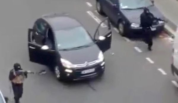 In this Wednesday Jan. 7, 2015, file photo, masked gunman fire their weapons outside the French satirical newspaper Charlie Hebdo's office in Paris - Sputnik International