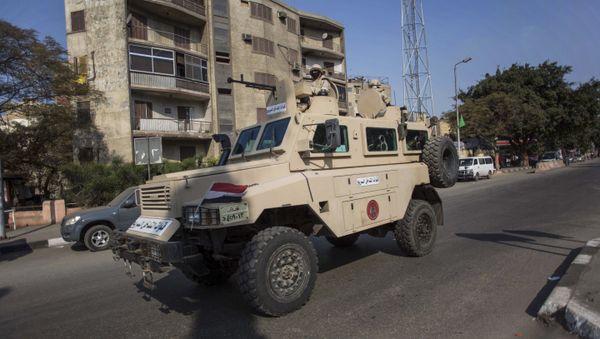 An Egyptian military vehicle patrols during anti-government demonstrations on Al Haram Street in Giza, a neighboring city of Cairo, Egypt, Friday, Nov. 28, 2014 - Sputnik International