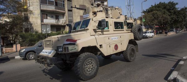 An Egyptian military vehicle patrols during anti-government demonstrations on Al Haram Street in Giza, a neighboring city of Cairo, Egypt, Friday, Nov. 28, 2014 - Sputnik International