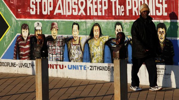 A pedestrian passes an AIDS education billboard in Johannesburg, South Africa. A pedestrian passes an AIDS education billboard in Johannesburg, South Africa. - Sputnik International