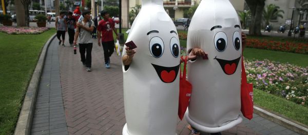 Two women dressed as condoms walk during an awareness program on International Condom Day in Lima, Peru. Two women dressed as condoms walk during an awareness program on International Condom Day in Lima, Peru. - Sputnik International