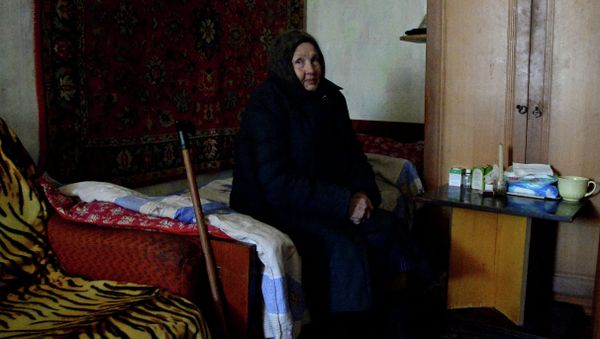 An old resident of Donetsk in an apartment of the house damaged in shelling. An old resident of Donetsk in an apartment of the house damaged in shelling. - Sputnik International