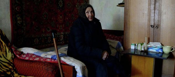 An old resident of Donetsk in an apartment of the house damaged in shelling. An old resident of Donetsk in an apartment of the house damaged in shelling. - Sputnik International