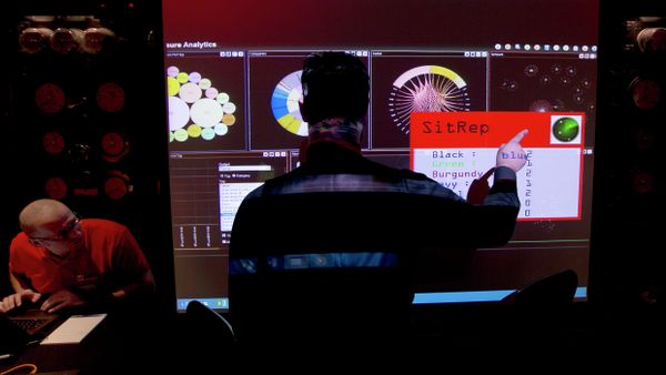 A representative of GCHQ points to a screen A representative of GCHQ points to a screen - Sputnik International
