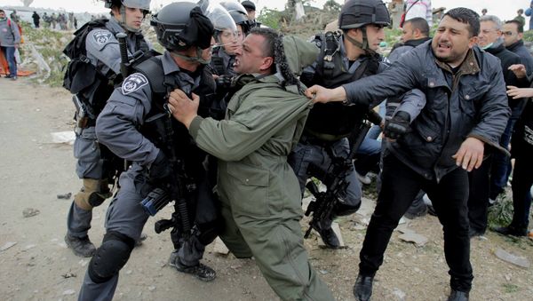A Palestinian man scuffles with Israeli border policemen as they clear a protest on land that Palestinians said was confiscated by Israel for Jewish settlements, near the West Bank town of Abu Dis near Jerusalem A Palestinian man scuffles with Israeli border policemen as they clear a protest on land that Palestinians said was confiscated by Israel for Jewish settlements, near the West Bank town of Abu Dis near Jerusalem - Sputnik International