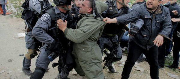 A Palestinian man scuffles with Israeli border policemen as they clear a protest on land that Palestinians said was confiscated by Israel for Jewish settlements, near the West Bank town of Abu Dis near Jerusalem A Palestinian man scuffles with Israeli border policemen as they clear a protest on land that Palestinians said was confiscated by Israel for Jewish settlements, near the West Bank town of Abu Dis near Jerusalem - Sputnik International