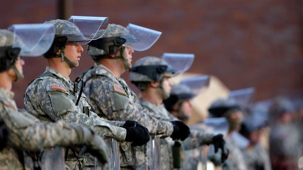National Guard troops stand in front of the Ferguson, Mo., Police Department a day after a grand jury's decision in the fatal shooting of Michael Brown. Newly released documents reveal that police planning for a grand jury announcement wanted Guard troops and armored Humvees stationed in the Ferguson neighborhood where Brown had been shot. - Sputnik International