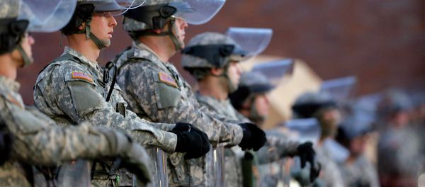 National Guard troops stand in front of the Ferguson, Mo., Police Department a day after a grand jury's decision in the fatal shooting of Michael Brown. Newly released documents reveal that police planning for a grand jury announcement wanted Guard troops and armored Humvees stationed in the Ferguson neighborhood where Brown had been shot. - Sputnik International