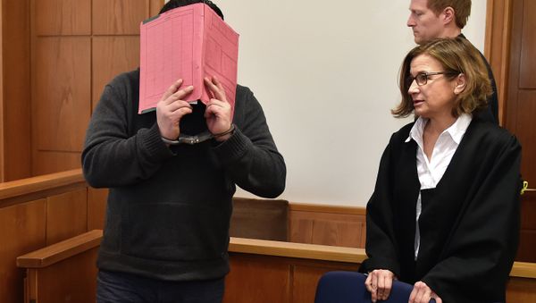 The former nurse identified only as Niels H. hides his face behind a folder while arriving in the courtroom beside his lawyer, Ulrike Baumann, in Oldenburg, Germany. The former nurse identified only as Niels H. hides his face behind a folder while arriving in the courtroom beside his lawyer, Ulrike Baumann, in Oldenburg, Germany. - Sputnik International