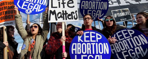 Abortion rights advocates hold signs while anti-abortion demonstrators walk by during the annual March for Life in Washington, DC. Abortion rights advocates hold signs while anti-abortion demonstrators walk by during the annual March for Life in Washington, DC. - Sputnik International