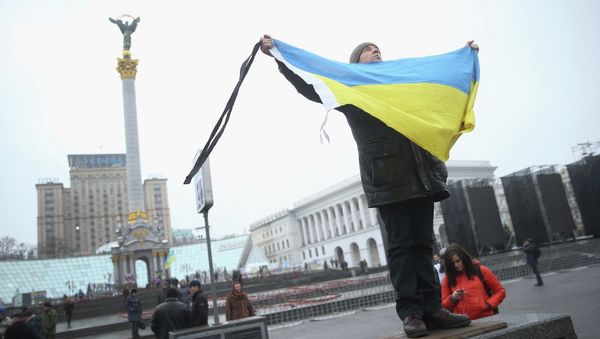 A participant marking the anniversary of the events on Kiev's Independence Square A participant marking the anniversary of the events on Kiev's Independence Square - Sputnik International