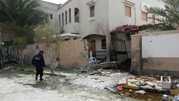 A security personnel stands near the site of a bomb blast at the gate of the Iranian ambassador's residence in Tripoli, February 22, 2015 A security personnel stands near the site of a bomb blast at the gate of the Iranian ambassador's residence in Tripoli, February 22, 2015 - Sputnik International