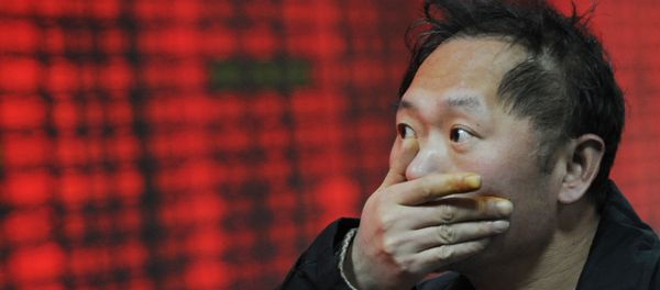 An investor gestures in front of a stock price board showing the red colour indicating rising prices at a private securities firm in Shanghai An investor gestures in front of a stock price board showing the red colour indicating rising prices at a private securities firm in Shanghai - Sputnik International