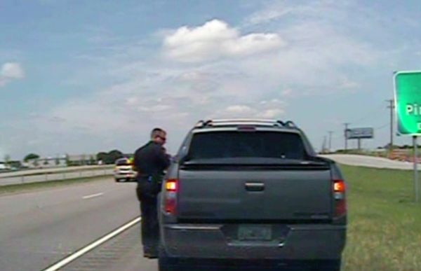 A police officer speaks with George Zimmerman after he was pulled over for speeding along U.S. 80, about 20 miles east of Dallas on Sunday, July 28, 2013. Zimmerman was released with a warning. - Sputnik International