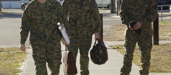 Cpl. Wassef Ali Hassoun, right, walks with defense attorneys Maj. Phillip E. Stackhouse, left, and Capt. Brandon Bolling for the first day of the Article 32 pre-trial investigation, Tuesday, Dec. 21, 2004, at Camp LeJeune, N.C. Hassoun is charged with desertion after he disappeared from his unit in Iraq and later claimed to be kidnapped. - Sputnik International