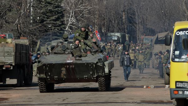 Independence supporters ride on an armored vehicle in the center of Debaltseve, Ukraine, Monday, Feb. 23, 2015 - Sputnik International