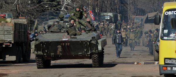 Independence supporters ride on an armored vehicle in the center of Debaltseve, Ukraine, Monday, Feb. 23, 2015 - Sputnik International