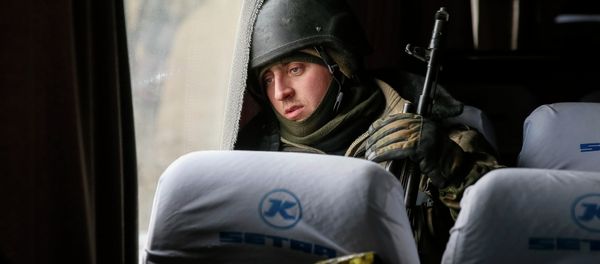 A Ukrainian serviceman who fought in Debaltseve is seen in a bus before leaving for his home, near Artemivsk February 19, 2015 - Sputnik International