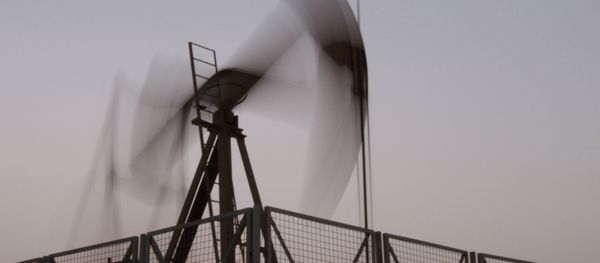 An oil pump jack works at sunset in the desert oil fields of Sakhir, Bahrain, Monday, June 10, 2013 - Sputnik International