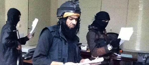 Shakir Waheib, a leader in the al-Qaida-linked Islamic State of Iraq and the Levant (ISIL), center, searching a government office in Ramadi, in Iraq's Anbar Province Shakir Waheib, a leader in the al-Qaida-linked Islamic State of Iraq and the Levant (ISIL), center, searching a government office in Ramadi, in Iraq's Anbar Province - Sputnik International