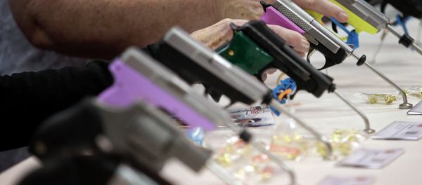 Attendees look over a pistol display at the National Rifle Association's annual convention. Attendees look over a pistol display at the National Rifle Association's annual convention. - Sputnik International
