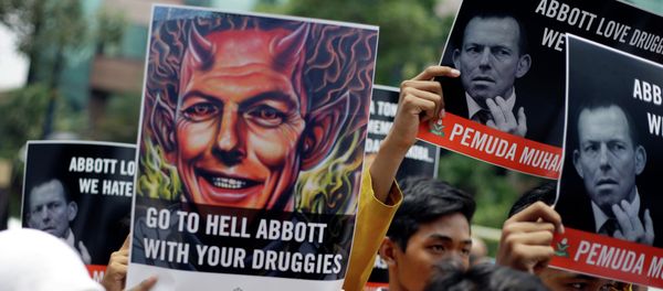 Indonesian Muslim students hold up posters during a protest against Australian Prime Minister Tony Abbott Indonesian Muslim students hold up posters during a protest against Australian Prime Minister Tony Abbott - Sputnik International