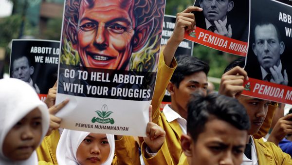 Indonesian Muslim students hold up posters during a protest against Australian Prime Minister Tony Abbott Indonesian Muslim students hold up posters during a protest against Australian Prime Minister Tony Abbott - Sputnik International
