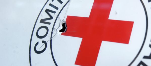 A bullet hole is seen on a sign, on a Red Cross office after shelling, in the town of Donetsk, eastern Ukraine A bullet hole is seen on a sign, on a Red Cross office after shelling, in the town of Donetsk, eastern Ukraine - Sputnik International