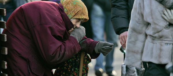 A pensioner begs for money as pedestrians pass by in central Kiev, Ukraine A pensioner begs for money as pedestrians pass by in central Kiev, Ukraine - Sputnik International