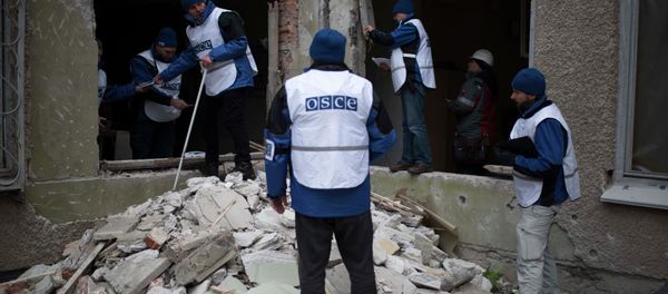 Organization for Security and Co-operation in Europe (OSCE) monitors investigate outside a kindergarten damaged in Saturday's shelling in which scores of people were killed and injured in Mariupol Organization for Security and Co-operation in Europe (OSCE) monitors investigate outside a kindergarten damaged in Saturday's shelling in which scores of people were killed and injured in Mariupol - Sputnik International