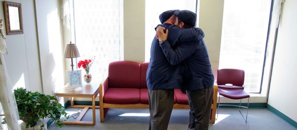 Charles Windham, left, 53, and Edgard Perez, 40, embrace after they were married at the marriage license bureau - Sputnik International