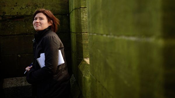 Reuters reporter Maria Golovnina stands atop a church steeple - Sputnik International