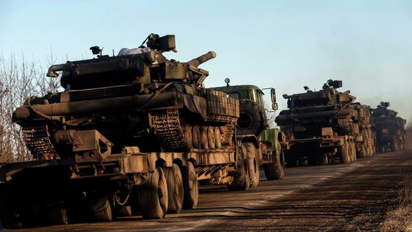 Military trucks from the Ukrainian armed forces transport tanks on the road near Artemivsk, eastern Ukraine, February 24, 2015 - Sputnik International