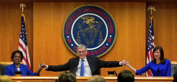 FCC Chairman Tom Wheeler joins hands with Commissioners Mignon Clyburn and Jessica Rosenworcel. FCC Chairman Tom Wheeler joins hands with Commissioners Mignon Clyburn and Jessica Rosenworcel. - Sputnik International