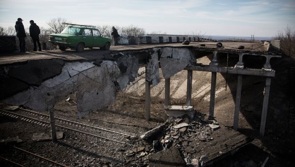 A car drives over a partially destroyed bridge on February 25, 2015 in Debaltseve, Ukraine A car drives over a partially destroyed bridge on February 25, 2015 in Debaltseve, Ukraine - Sputnik International