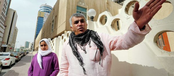 Human rights activist Nabeel Rajab (R) gestures as he walks with his daughter Malak Rajab to attend his appeal hearing at court in Manama, February 11, 2015 - Sputnik International