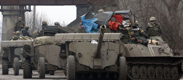 Ukrainian Armoured Personnel Carriers move cannons from their position near eastern Ukrainian city of Artemivsk, in the Donetsk region - Sputnik International