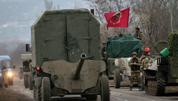 A convoy of Ukrainian armed forces including armoured personnel carriers, military vehicles and cannons prepare to move as they pull back from the Debaltseve region, in Paraskoviyvka, eastern Ukraine A convoy of Ukrainian armed forces including armoured personnel carriers, military vehicles and cannons prepare to move as they pull back from the Debaltseve region, in Paraskoviyvka, eastern Ukraine - Sputnik International
