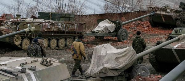 Ukrainian servicemen walk past armoured personnel carriers, military vehicles and cannons at their new position as they pull back from the Horlivka region, near Druzhkivka, eastern Ukraine Ukrainian servicemen walk past armoured personnel carriers, military vehicles and cannons at their new position as they pull back from the Horlivka region, near Druzhkivka, eastern Ukraine - Sputnik International