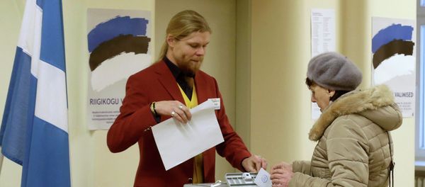 A woman casts her vote during a parliamentary election in Parnu A woman casts her vote during a parliamentary election in Parnu - Sputnik International