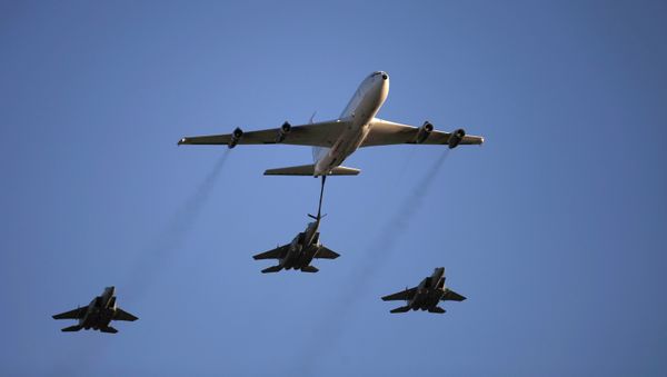 An Israeli Air Force Boeing 707 demonstrates refueling of an F15 fighter jet. - Sputnik International