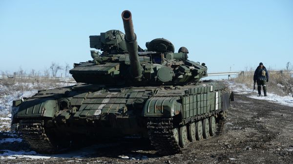 A self-defender of the Lugansk People's Republic near a captured T-64 tank in Debaltsevo. A self-defender of the Lugansk People's Republic near a captured T-64 tank in Debaltsevo. - Sputnik International