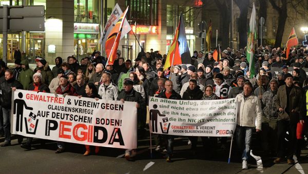People march during a demonstration of the socalled movement of Patriotic Europeans Against the Islamisation of the Occident aka Pegida, in Dresden People march during a demonstration of the socalled movement of Patriotic Europeans Against the Islamisation of the Occident aka Pegida, in Dresden - Sputnik International