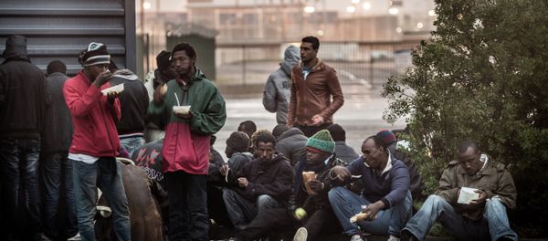 Migrants eat hot meals served by humanitarian organizations in the northeastern French port of Calais on October 29, 2014 Migrants eat hot meals served by humanitarian organizations in the northeastern French port of Calais on October 29, 2014 - Sputnik International