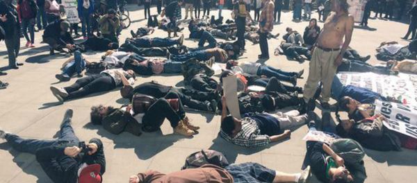 Many demonstrated staged a ‘die-in’ in front of the building to show solidarity for “Africa.” Many demonstrated staged a ‘die-in’ in front of the building to show solidarity for “Africa.” - Sputnik International