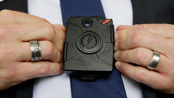 Feb. 19, 2015, Steve Tuttle, vice president of communications for Taser International, demonstrates one of the company's body cameras - Sputnik International
