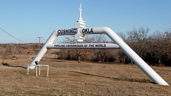 This Wednesday, Feb. 1, 2012 photo shows a marker declaring Cushing, Okla. as the pipeline crossroads of the world, in Cushing. For the past seven weeks, the United States has been producing and importing an average of 1 million more barrels of oil every day than it is consuming. This Wednesday, Feb. 1, 2012 photo shows a marker declaring Cushing, Okla. as the pipeline crossroads of the world, in Cushing. For the past seven weeks, the United States has been producing and importing an average of 1 million more barrels of oil every day than it is consuming. - Sputnik International