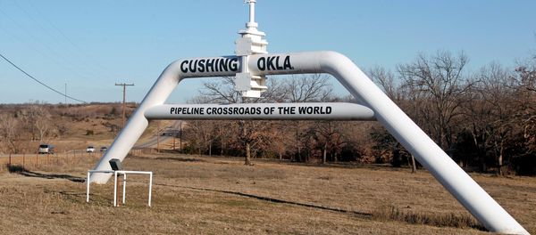 This Wednesday, Feb. 1, 2012 photo shows a marker declaring Cushing, Okla. as the pipeline crossroads of the world, in Cushing. For the past seven weeks, the United States has been producing and importing an average of 1 million more barrels of oil every day than it is consuming. - Sputnik International