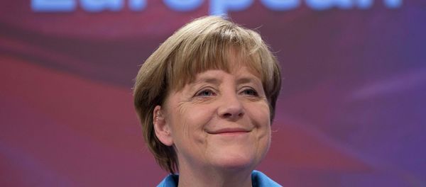 German Chancellor Angela Merkel smiles during a joint news conference with European Commission President Jean-Claude Juncker at the EC headquarters in Brussels March 4, 2015 - Sputnik International